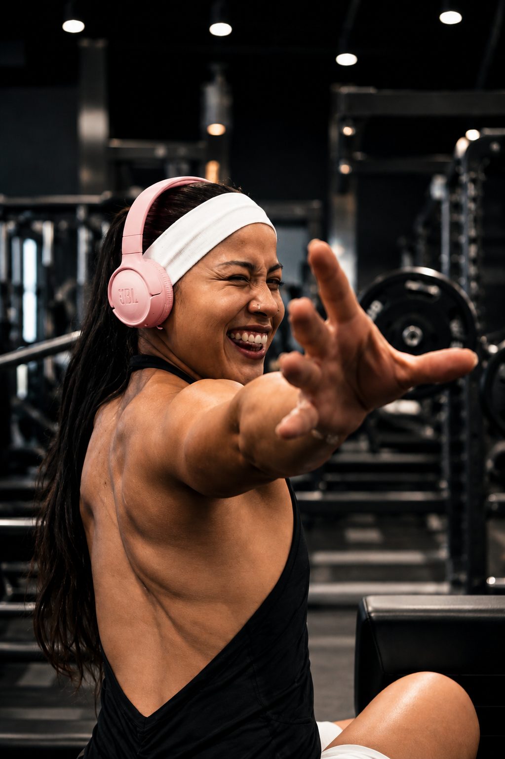 Vic laughing and reaching toward the camera in the gym